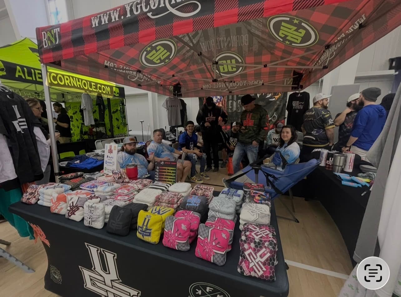 YG Cornhole booth and players at a community market